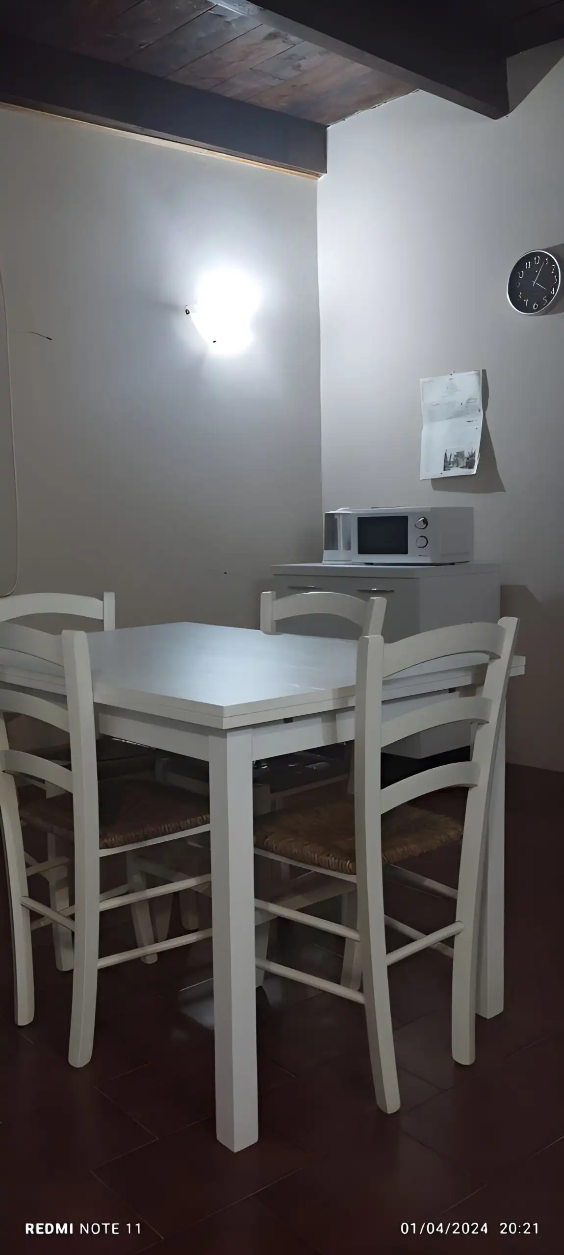 Interior view of a small kitchen with dining table in a Sardinian apartment.