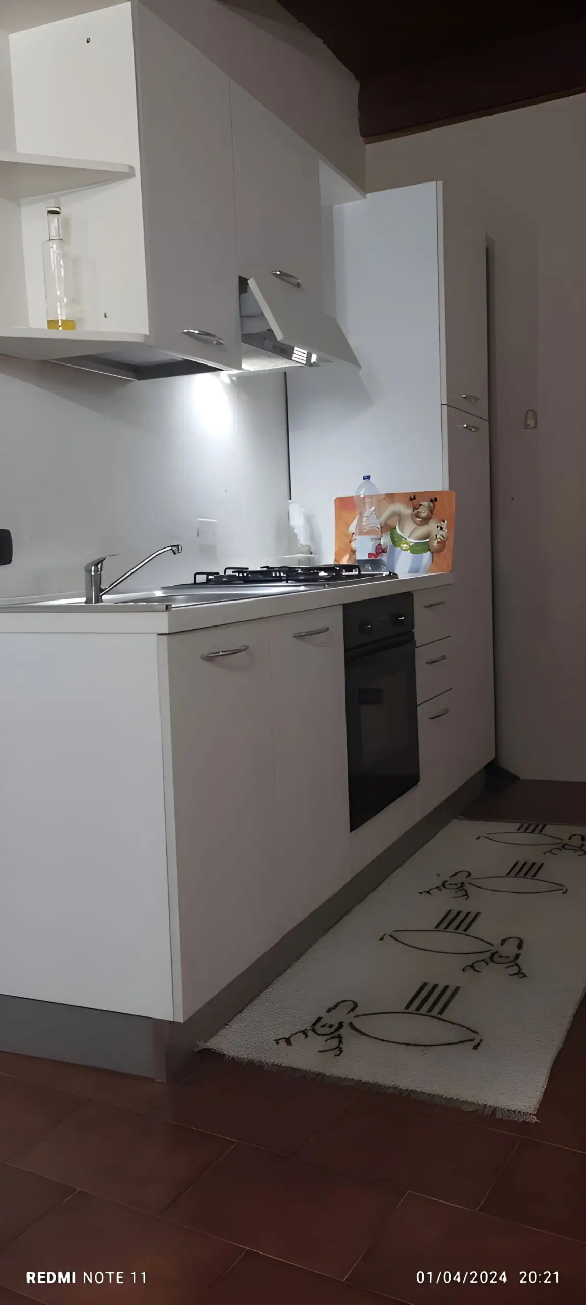 Modern compact kitchen in a historic village apartment in Pattada, Sardinia, Italy.
