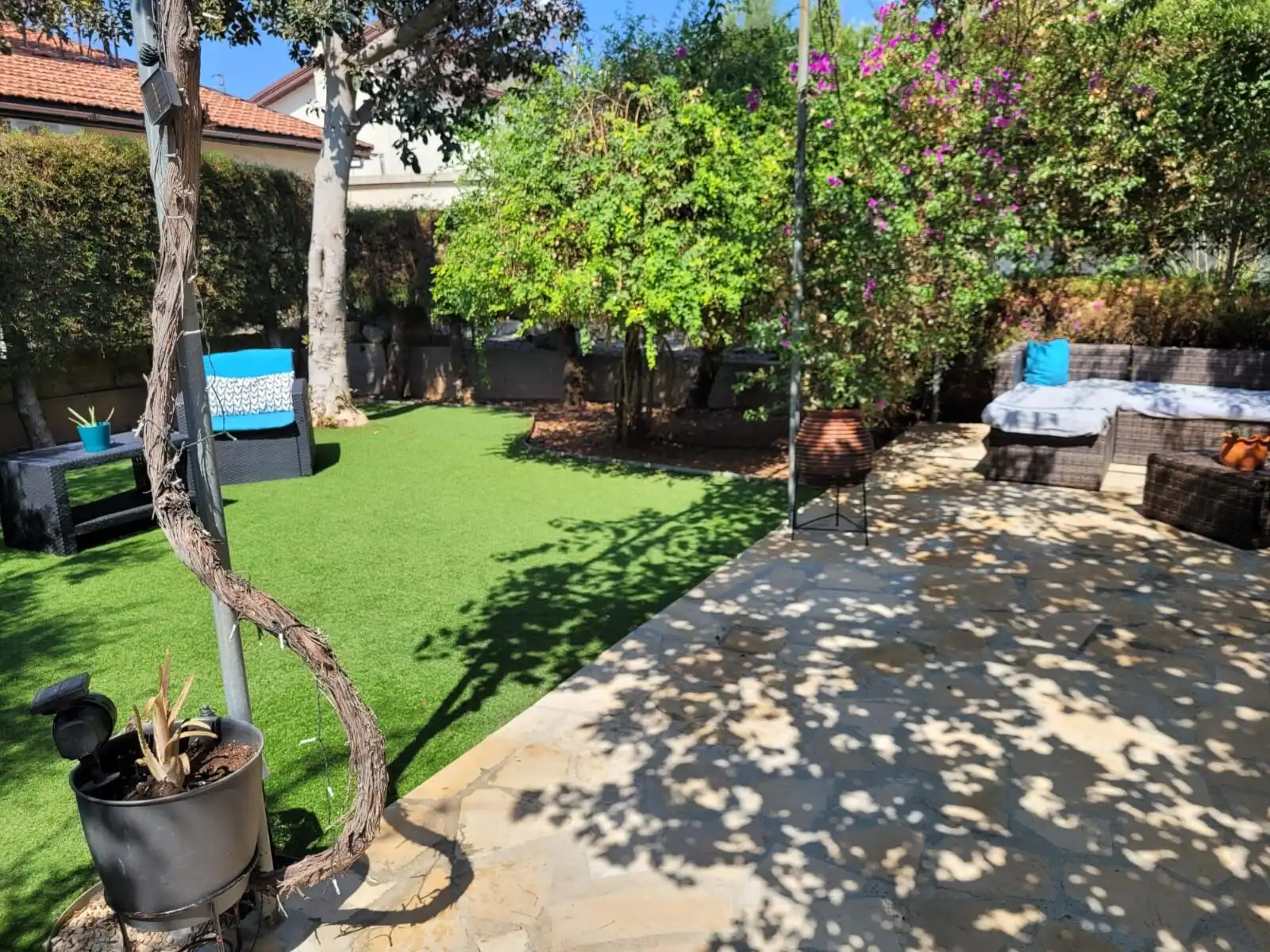 Beautiful garden with lush greenery and outdoor seating in Limassol countryside.