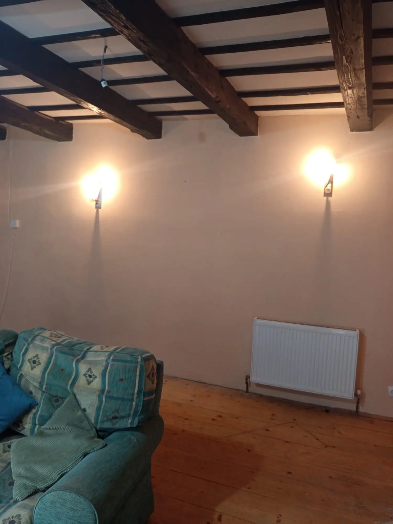 Bright living room with wooden beams and modern lighting in Brasov property.