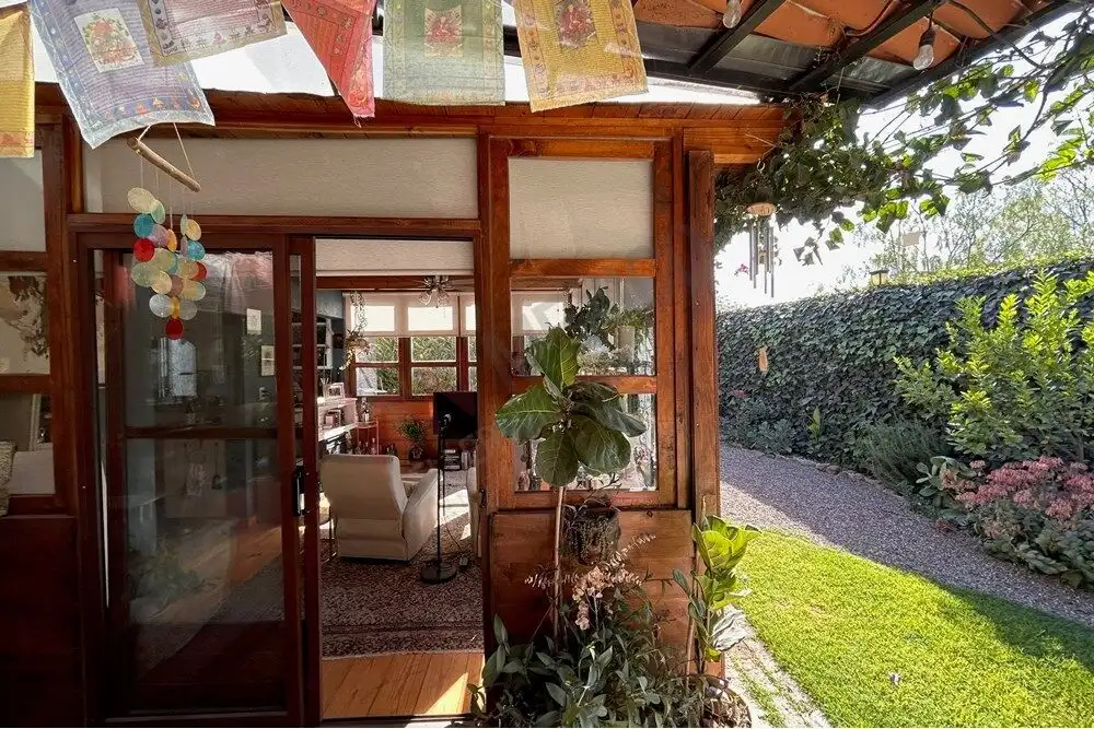Style home entrance with lush garden and outdoor seating area in Rancho Los Labradores.
