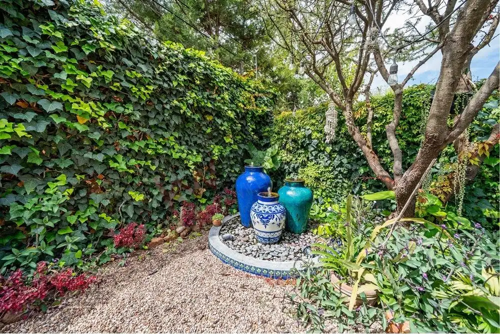 Beautiful garden corner featuring colorful ceramic vases and lush greenery in Rancho Los Labradores.