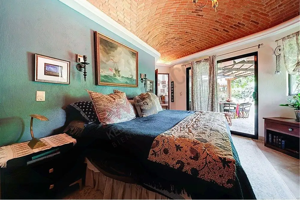 Cozy bedroom with colonial decor, exposed brick ceiling, and elegant furnishings in Rancho Los Labra.