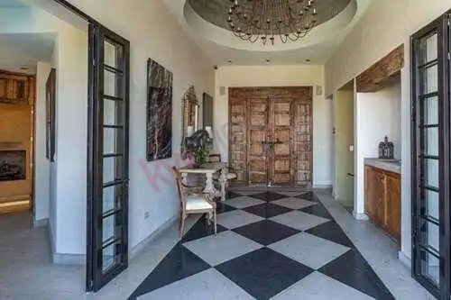 Elegant interior hallway with wooden accents and decorative elements in a luxurious estate.