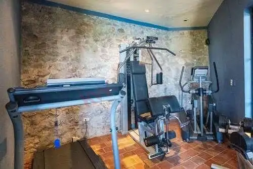 Home gym featuring exercise machines and workout area in a contemporary setting.
