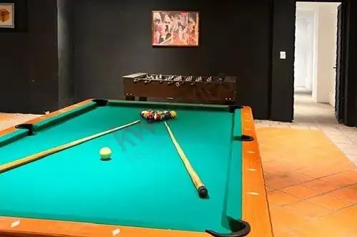 Pool table and foosball in a stylish entertainment area.