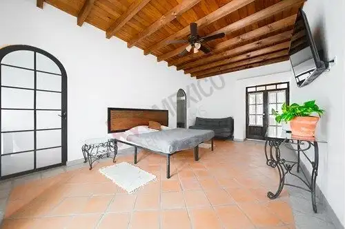 Elegant bedroom in San Miguel de Allende featuring a wooden ceiling and modern decor. Perfect turnke.