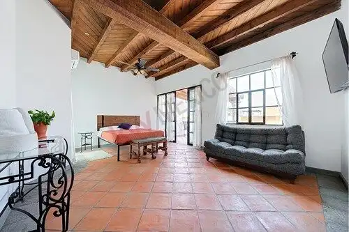 Beautiful interior of a luxury investment property in San Miguel de Allende with high wooden ceiling.