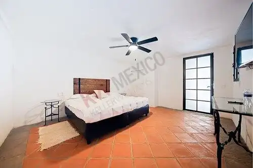Spacious bedroom in a luxury property in San Miguel de Allende with modern decor and terracotta floo.