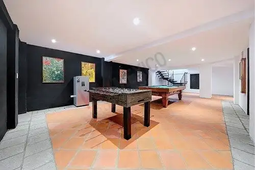 Luxury game room featuring a pool table and vibrant artwork in San Miguel de Allende.