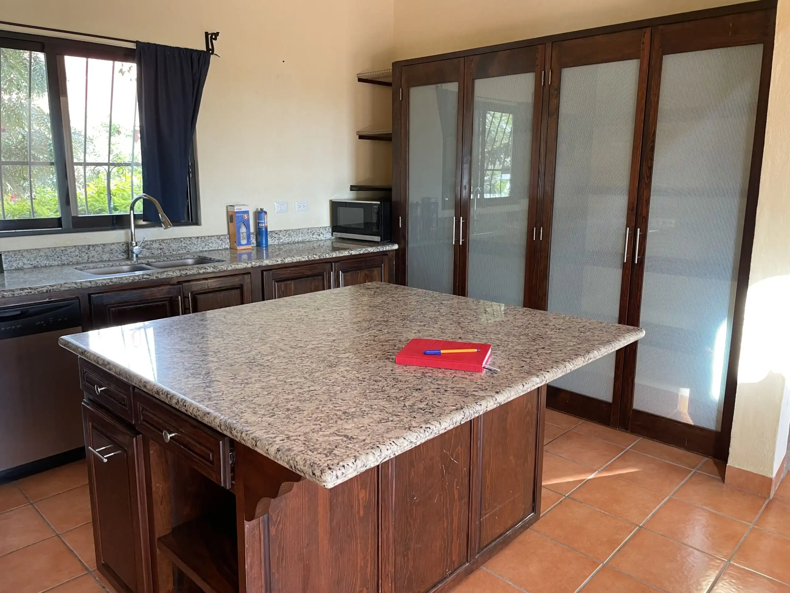 Bright kitchen featuring granite countertops and ample storage in Rancho Los Labradores, San Miguel.