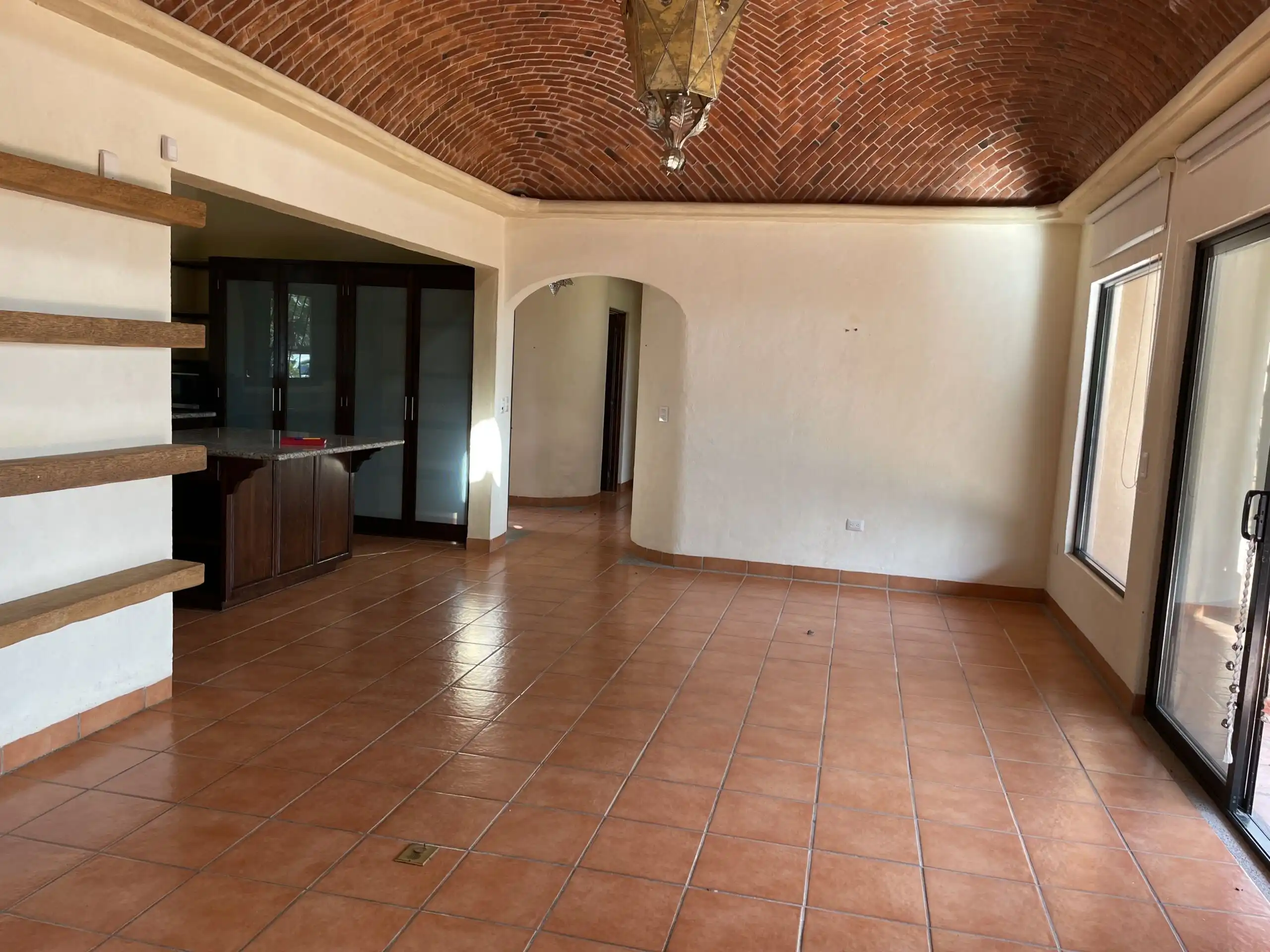 Bright living space with terracotta tiles and a vaulted brick ceiling in Rancho Los Labradores.
