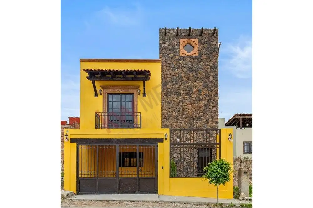 Beautiful yellow modern home with a stone tower in Colonia San Rafael, offering unique architectural.