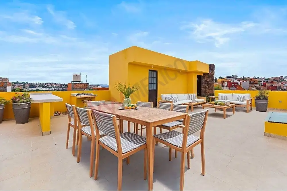 Rooftop terrace with outdoor dining and seating area in San Miguel de Allende.