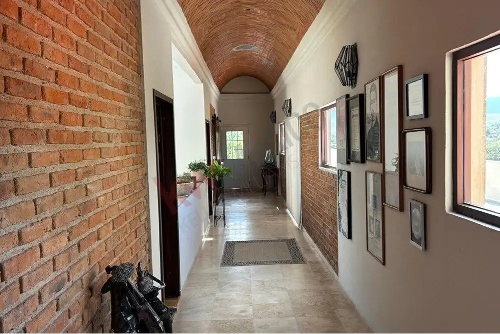 Luxury Country Estate Hallway in San Miguel de Allende Elegant hallway inside a luxury estate in San Miguel de Allende, showcasing brick and white walls wi.