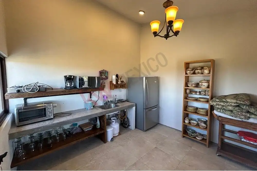 Luxury Country Estate for Sale in San Miguel de Allende Elegant kitchen with modern appliances and rustic wooden shelves in a luxury estate.