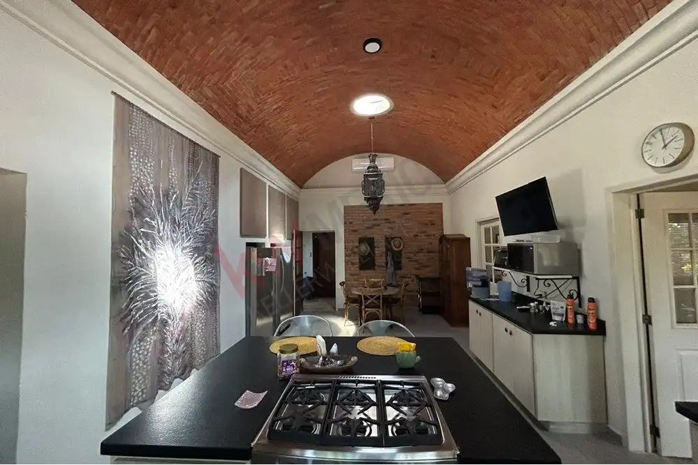 Elegant country estate kitchen in San Miguel de Allende with modern appliances and rustic design elements. Elegant country estate kitchen in San Miguel de Allende with modern appliances and rustic design ele.