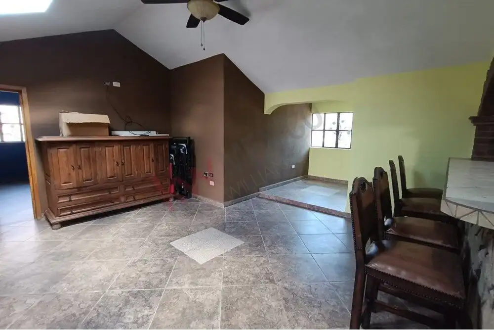 Spacious interior of Casa Rincón del Cielo featuring a warm living space with rustic furniture and s.