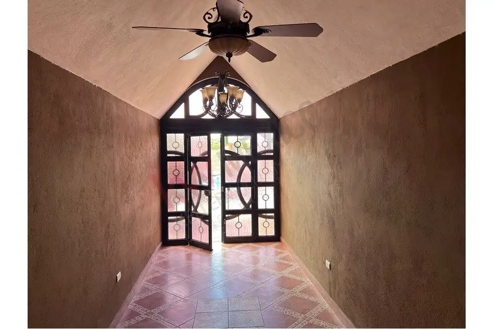Entrance hall featuring decorative glass doors and warm lighting.