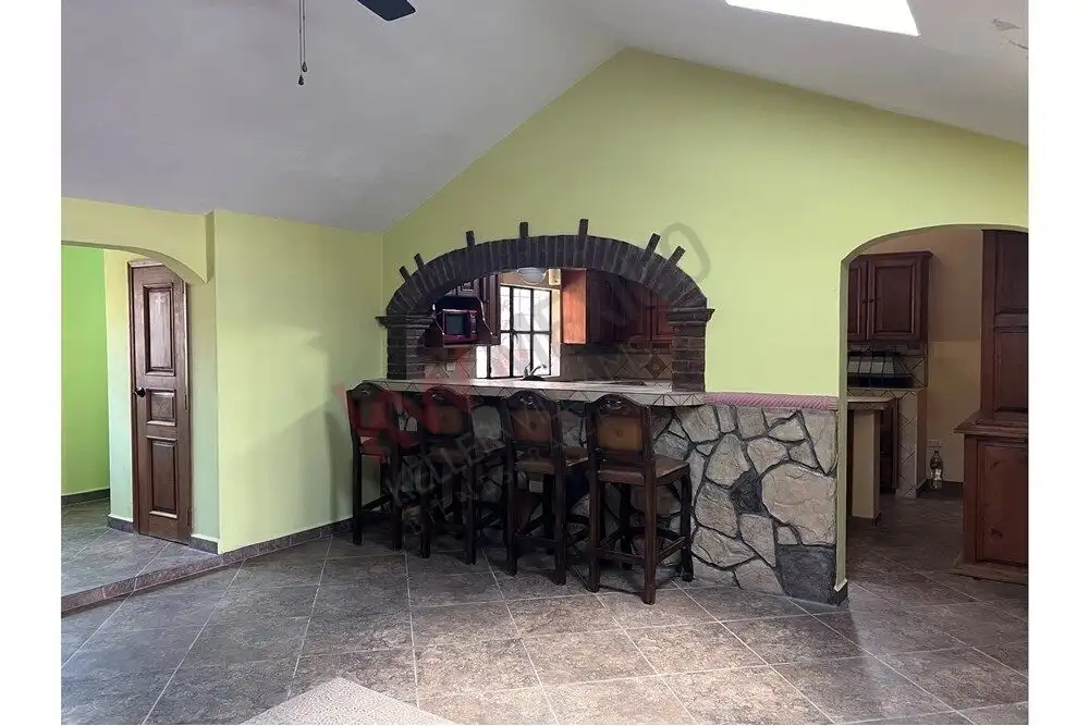 Interior view of a rustic kitchen with a bar counter and stone accents, perfect for countryside retr.