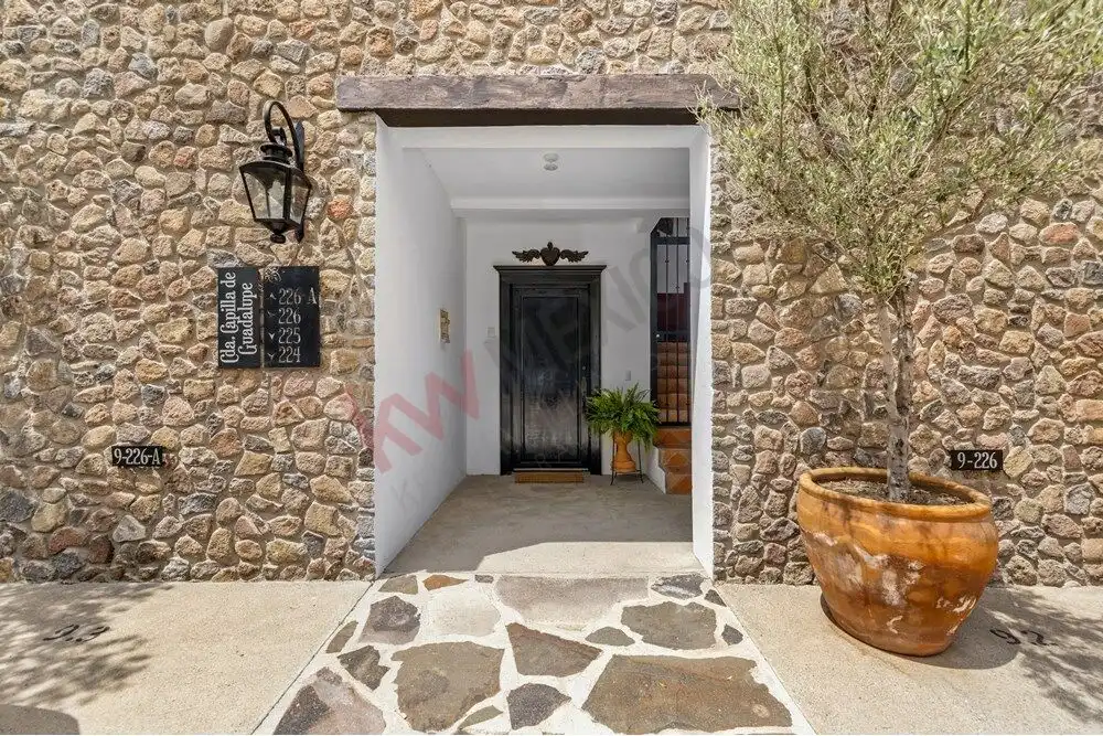 Level home entrance in Capilla de Piedra, San Miguel de Allende, featuring stone walls and modern de.