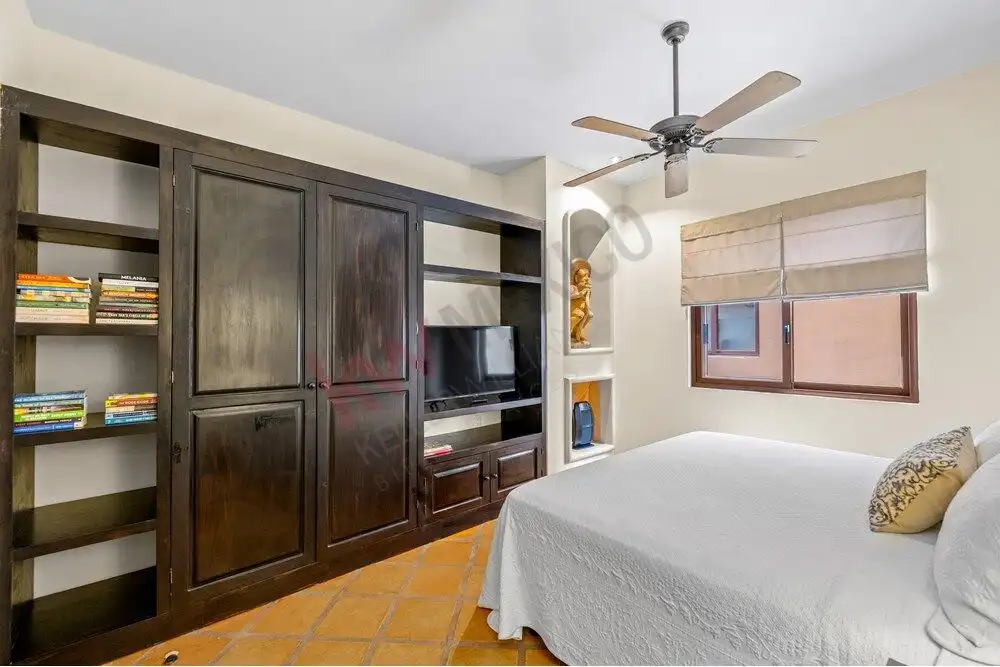 Cozy bedroom with built-in storage and modern decor in Capilla de Piedra.