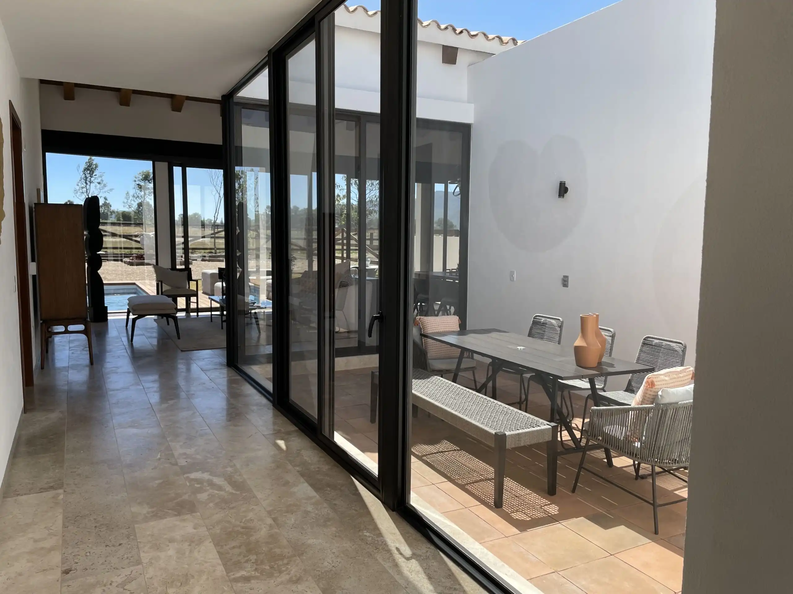 Outdoor living space with glass doors and patio furniture.