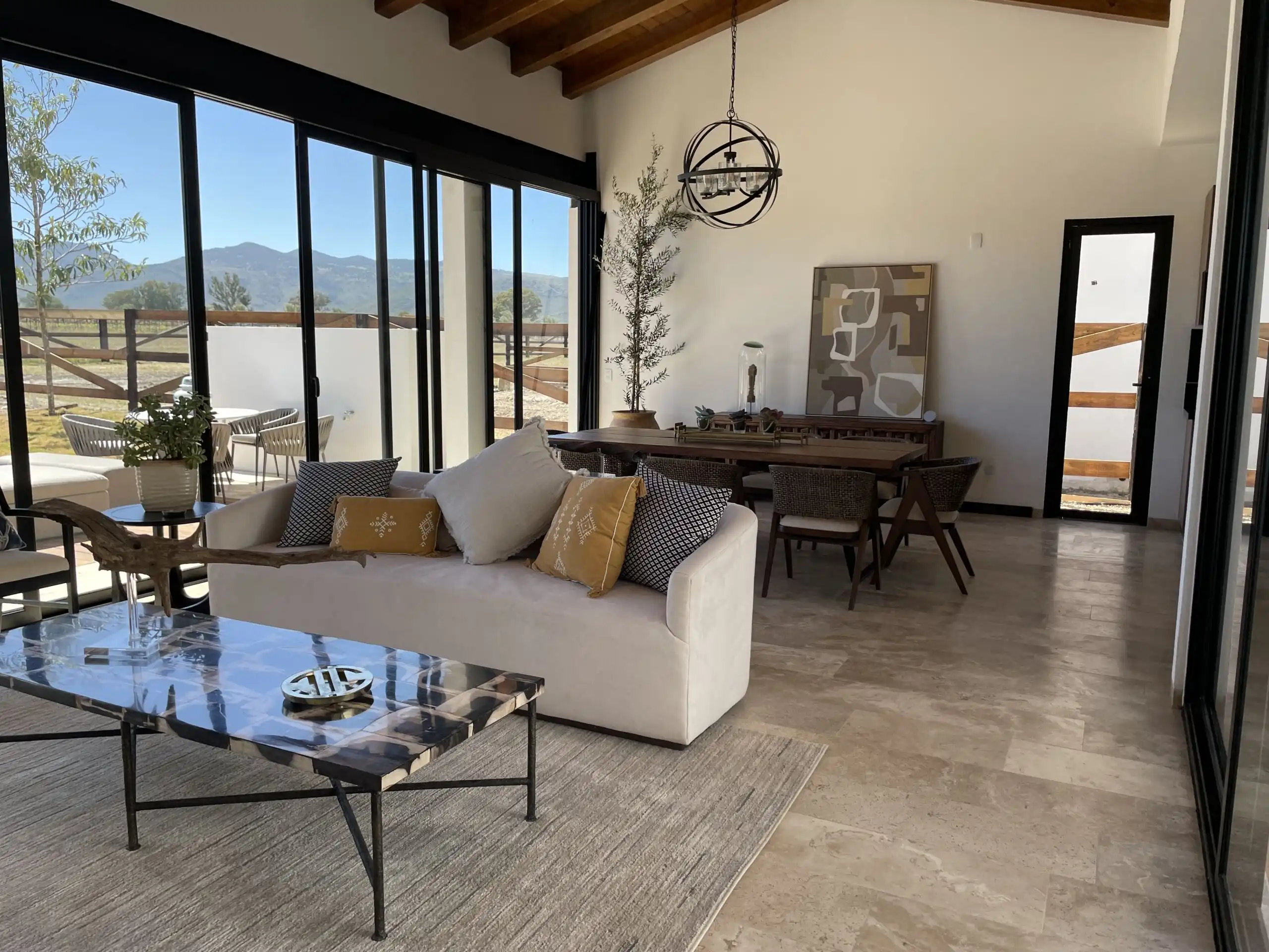 Elegant living room with panoramic mountain views and modern decor.
