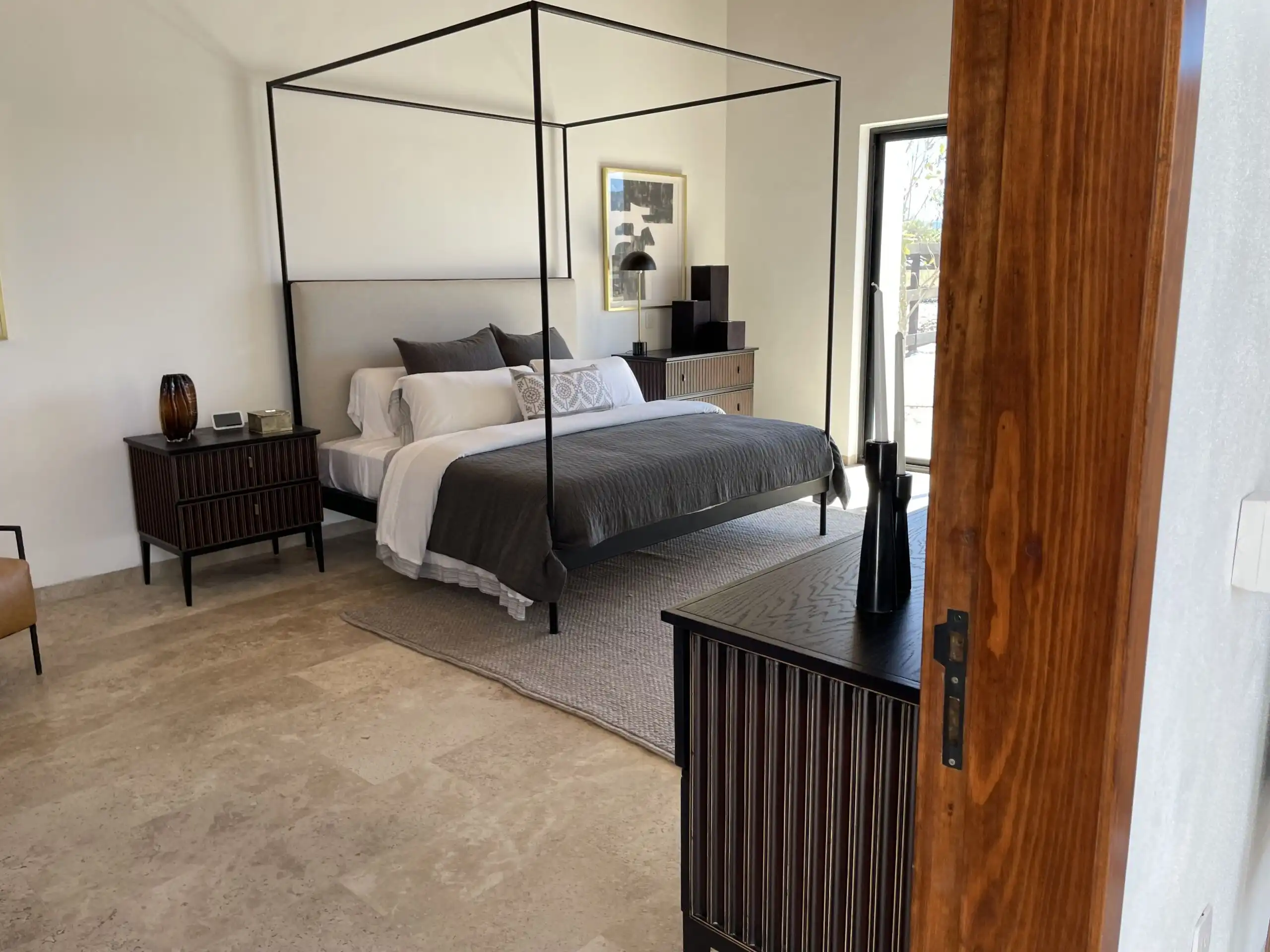 Elegant bedroom with modern decor and a four-poster bed in La Santa Vid.