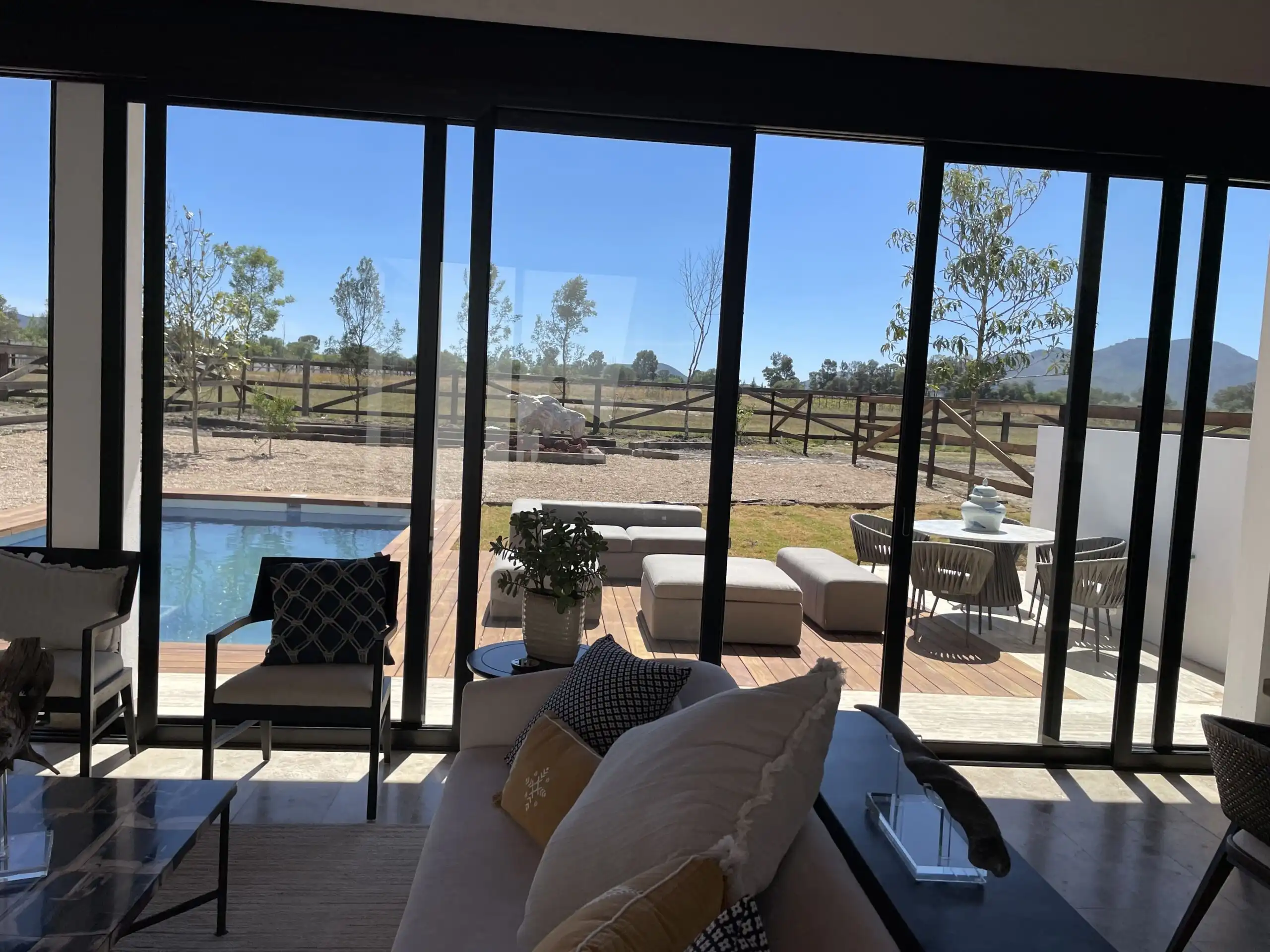 Elegant interior with panoramic views of outdoor landscape.