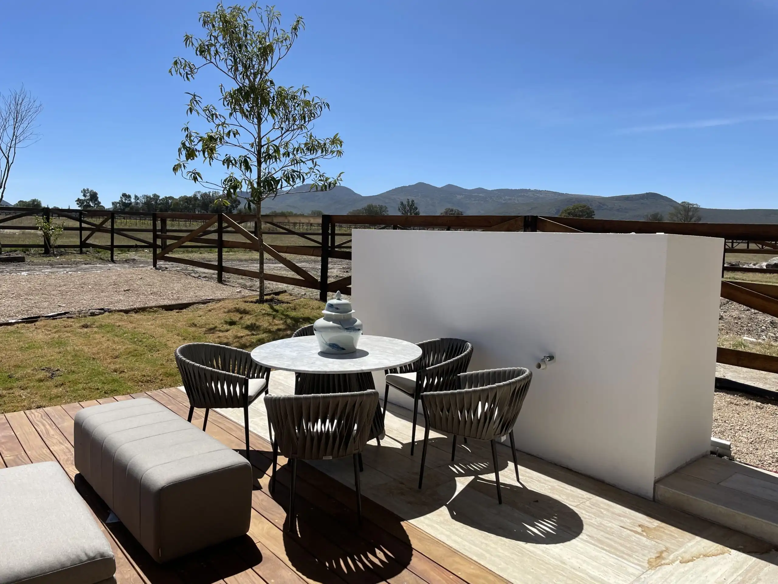 Outdoor terrace with seating area and mountain backdrop in San Miguel de Allende.