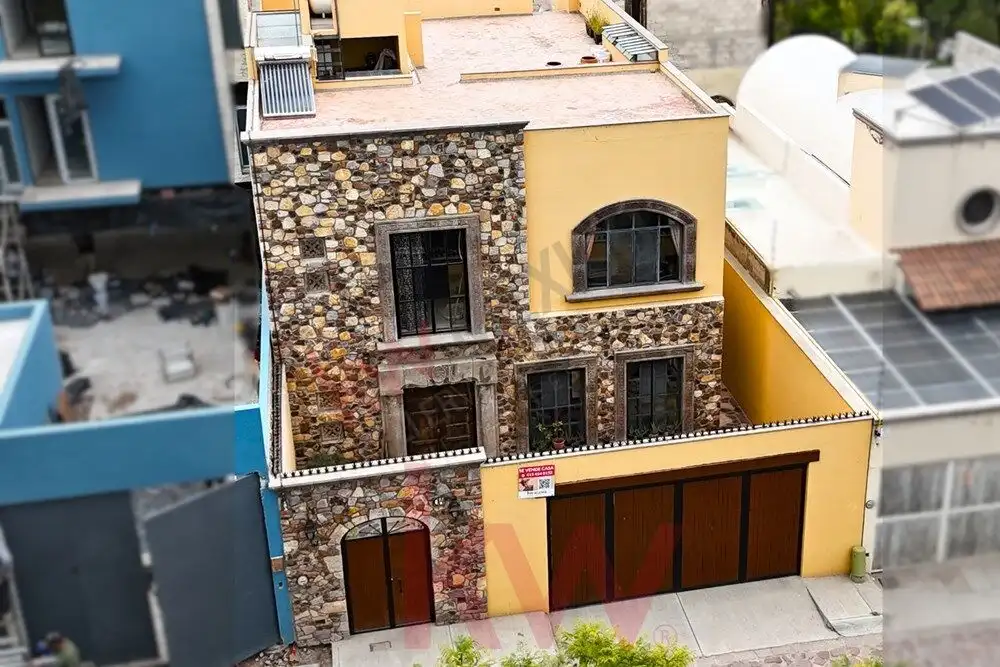 Style Home in San Miguel de Allende Style 4-bedroom home for sale on Avenida Paseo Real, San Miguel de Allende, featuring stone accents.