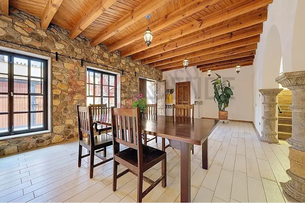 Style 4-Bedroom Home Interior Style dining room with wooden beams and stone walls in San Miguel de Allende.