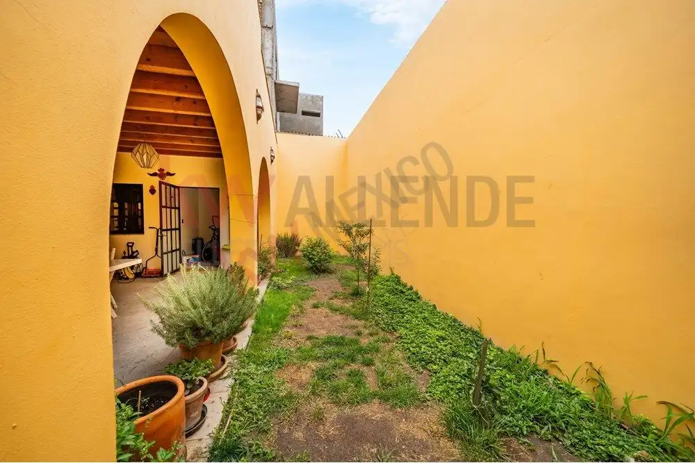 Style Home in San Miguel de Allende Style 4-bedroom home for sale on Avenida Paseo Real, San Miguel de Allende, featuring vibrant yellow.