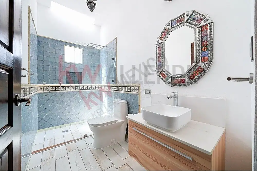 Style Bathroom in San Miguel de Allende Bright bathroom featuring a modern sink, decorative mirror, and spacious shower area.