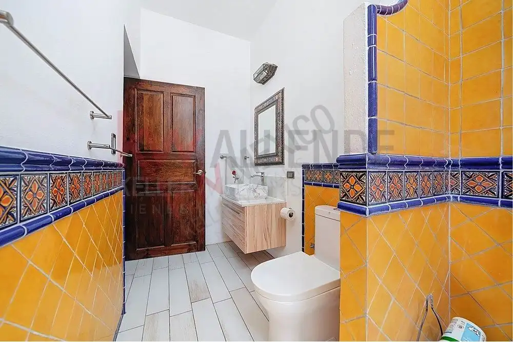 Style 4-Bedroom Home for Sale Style bathroom with vibrant yellow and blue tiles in San Miguel de Allende.