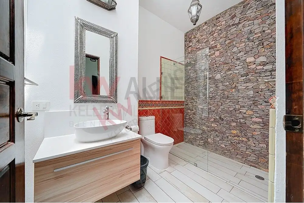 Charming Colonial Bathroom with Stone Accent Wall Beautiful bathroom featuring a stone accent wall, modern fixtures, and elegant decor in a colonial-s.