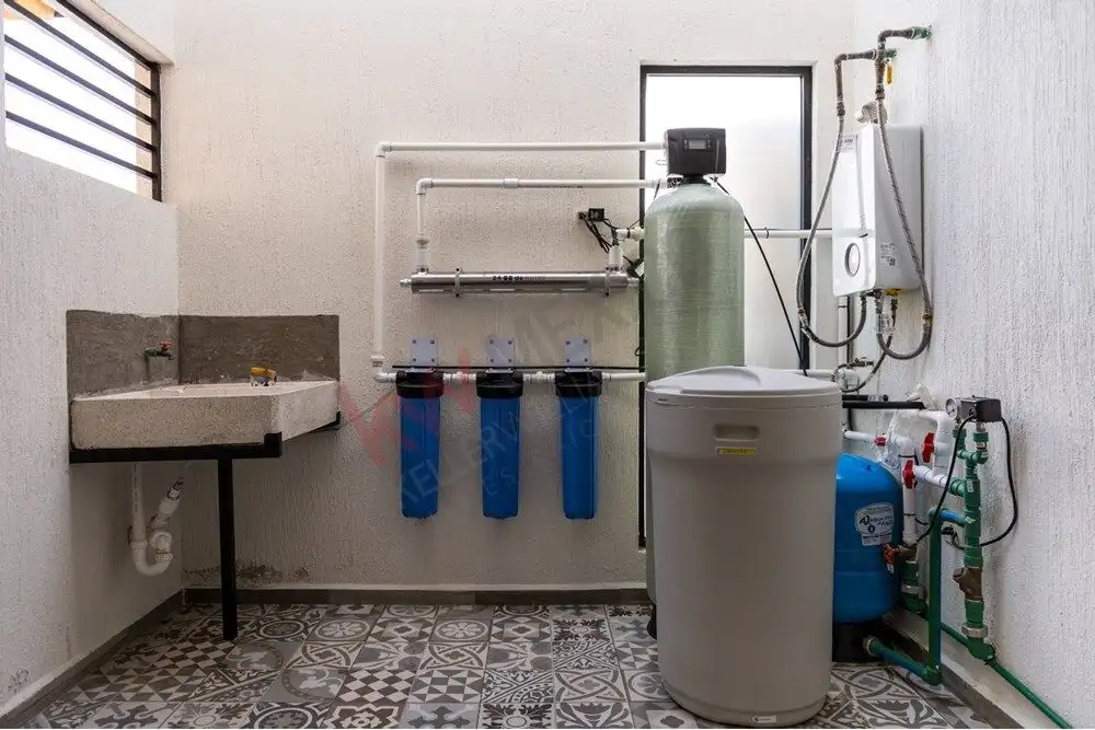 Efficient water filtration system with multiple filters and a water softener in a modern utility roo.