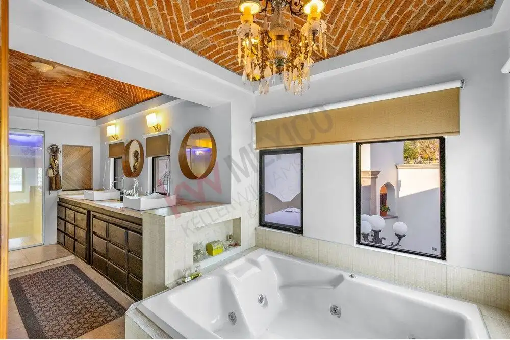 Style bathroom featuring a Jacuzzi tub and large windows with scenic views.