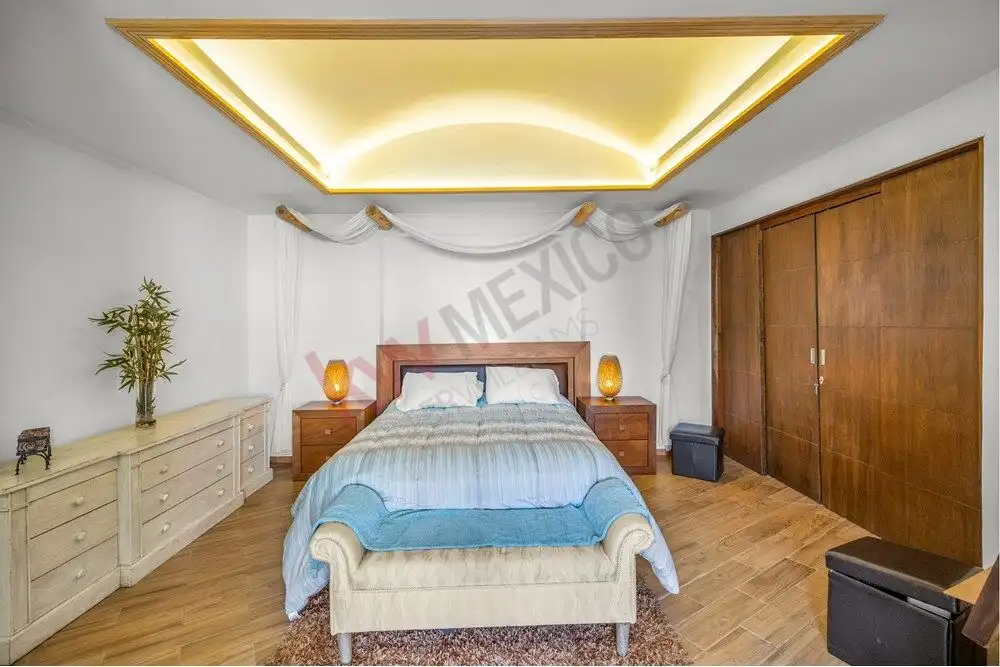 Elegant bedroom with panoramic views and modern decor in San Miguel de Allende.