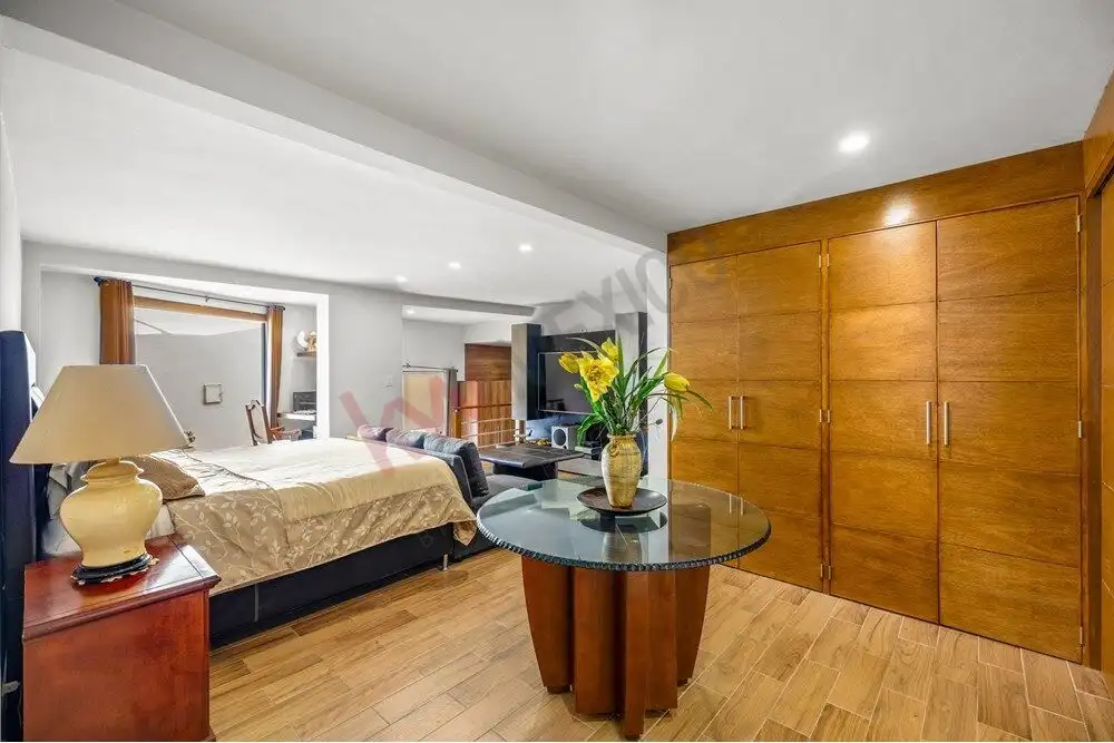 Elegant bedroom with wooden accents and panoramic views in a colonial-style home.