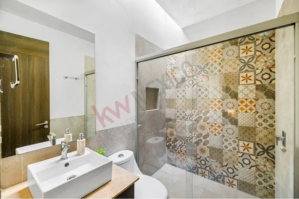Bright bathroom with patterned tile shower in a modern home for sale in Quinta de Allende.