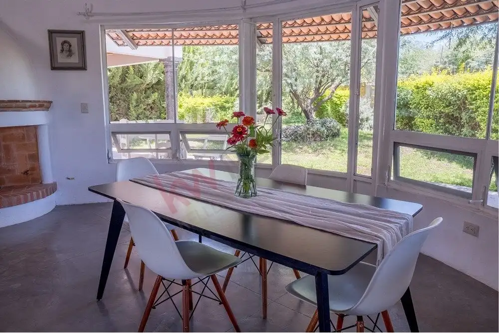 Modern Rancho Los Labradores Home Bright dining room with large windows in San Miguel de Allende.