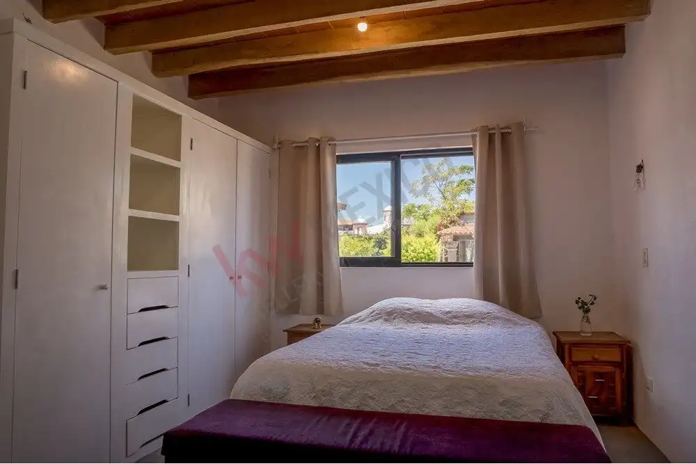 Cozy Modern Bedroom in Rancho Los Labradores Bright bedroom with large window and wooden ceiling beams in a modern house.