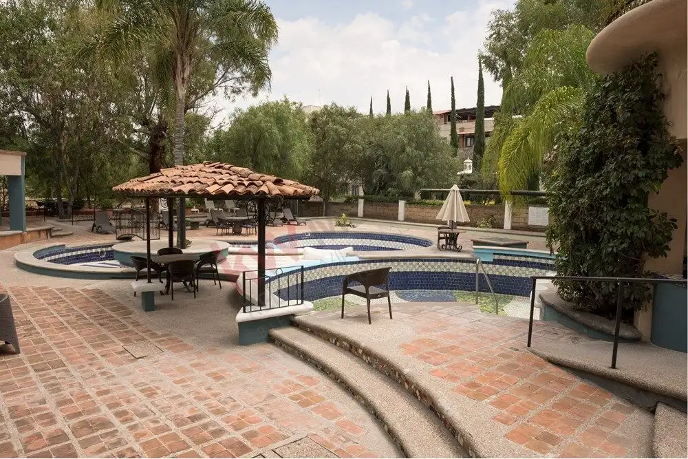 Modern house with pool in Rancho Los Labradores, San Miguel de Allende. Beautiful outdoor pool area with seating and shaded gazebo in a luxurious residential community.