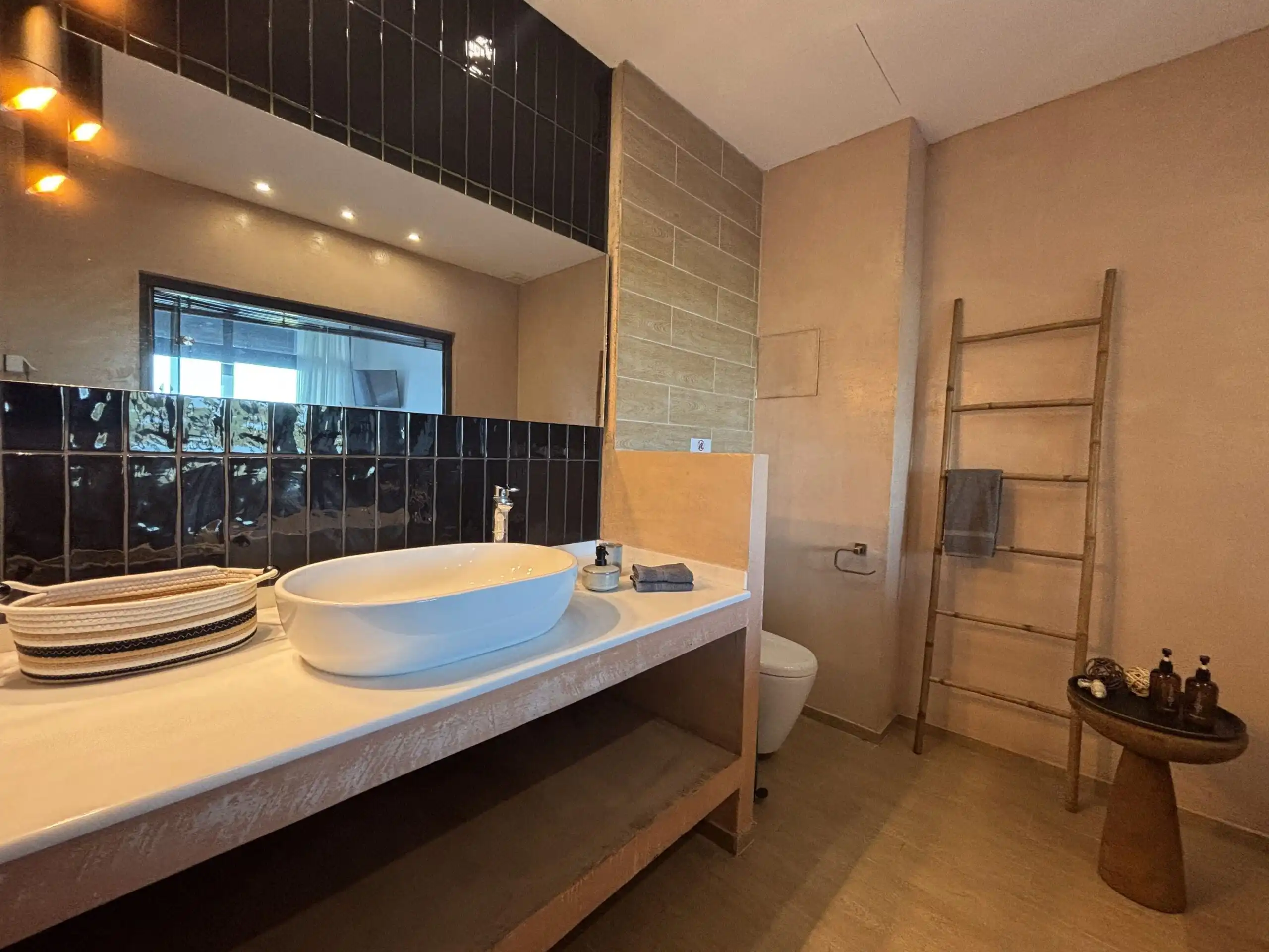 View villa bathroom with modern fixtures and decor.