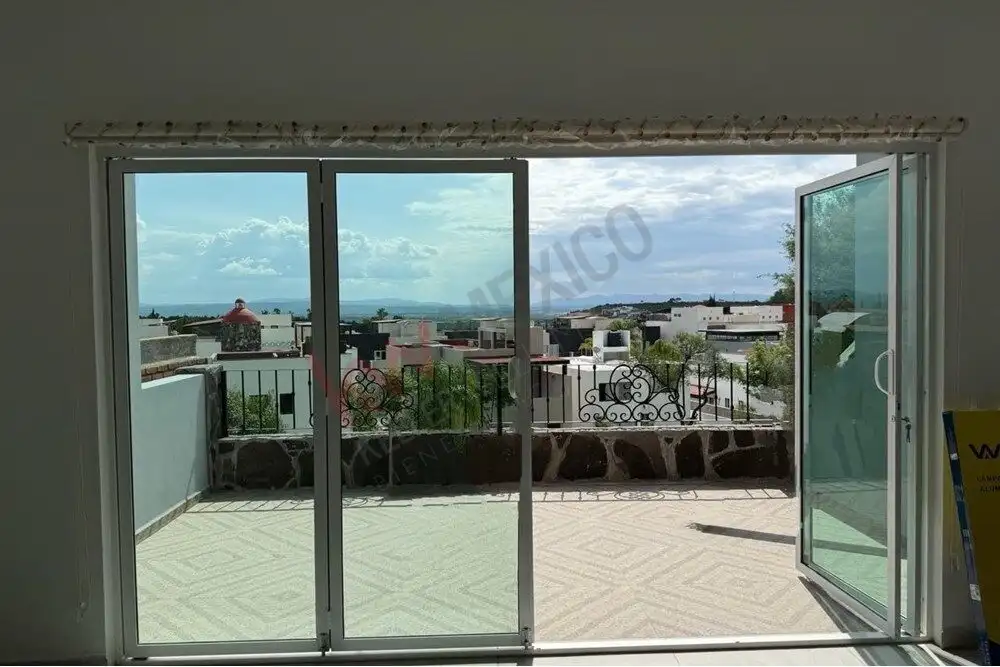 Bright living room opening to balcony with ocean view.