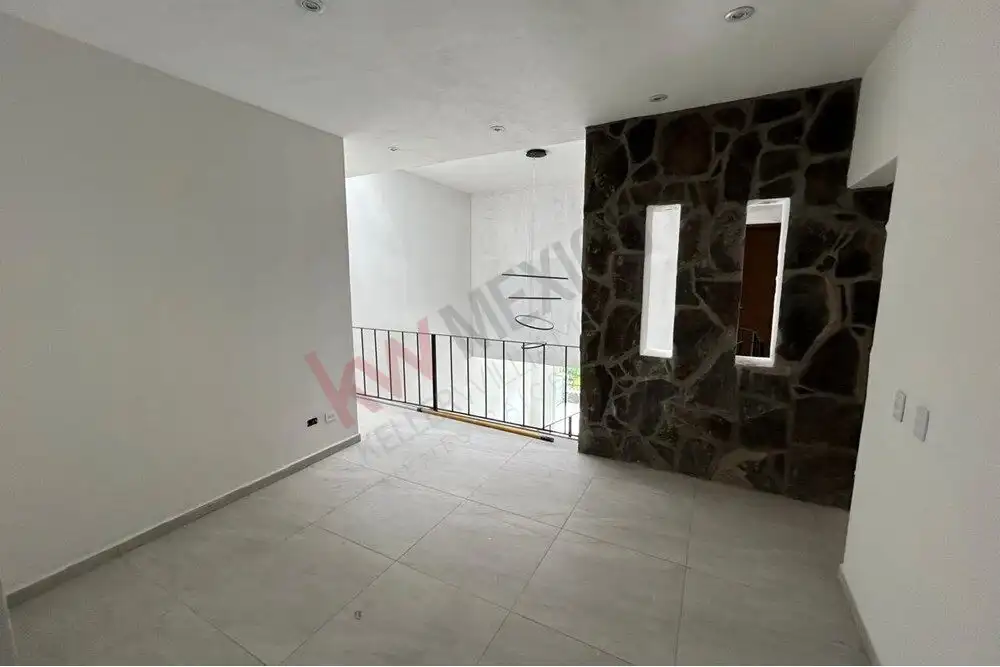 Spacious living area with natural light and minimalist design.