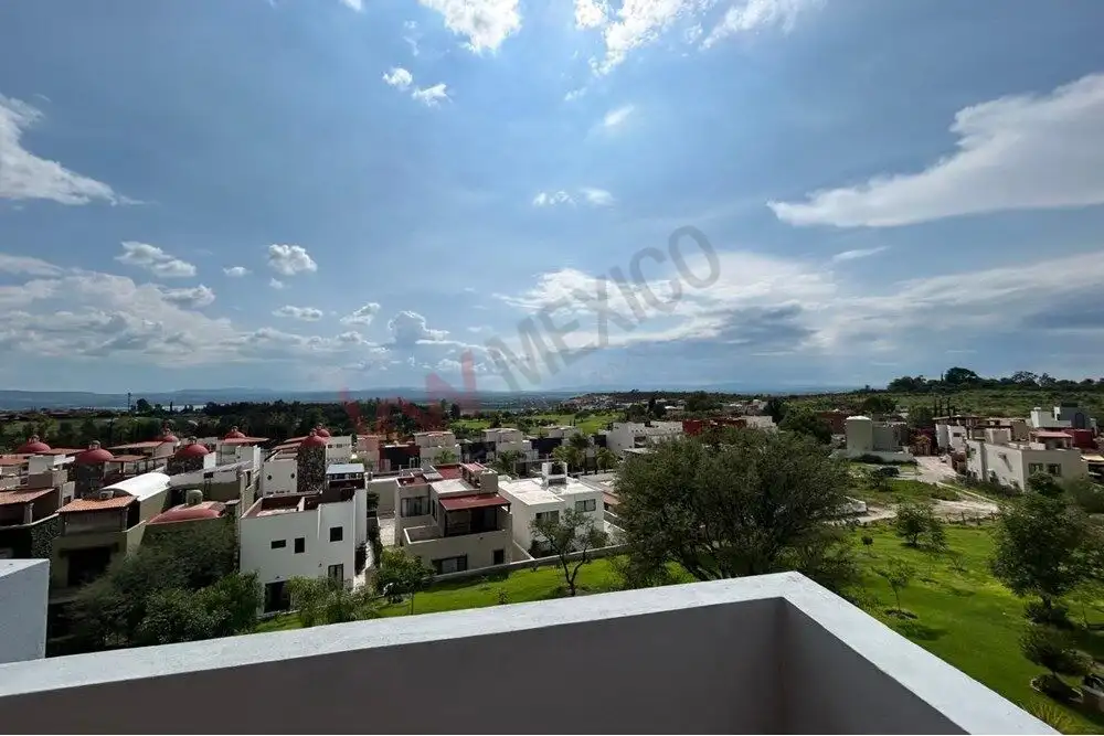 Panoramic view of San Miguel de Allende homes and landscape from a balcony.