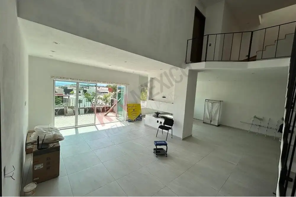 Spacious interior with bright natural light, open layout, and balcony overlooking the city in a styl.